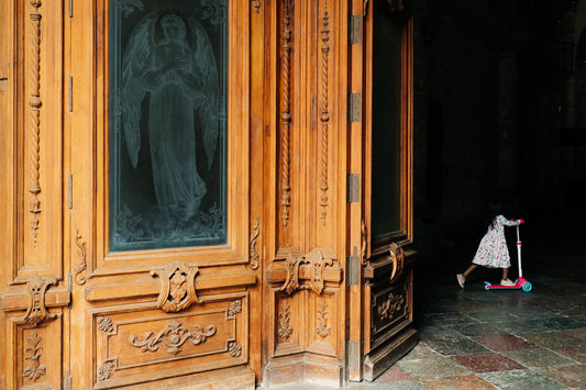 Photographic Art by Nick Sparks of a Oaxacan girl riding a scooter through a church. 