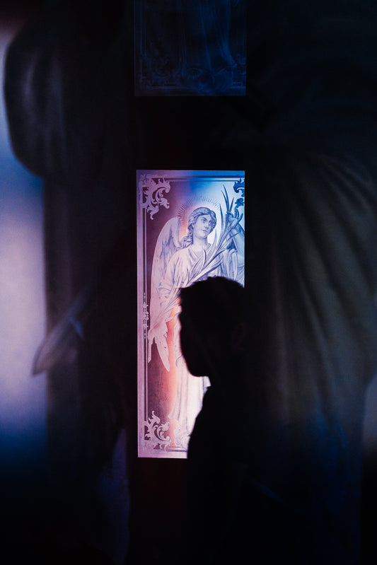 Photographic Art by Nick Sparks of a silhouetted person walking through  church. 