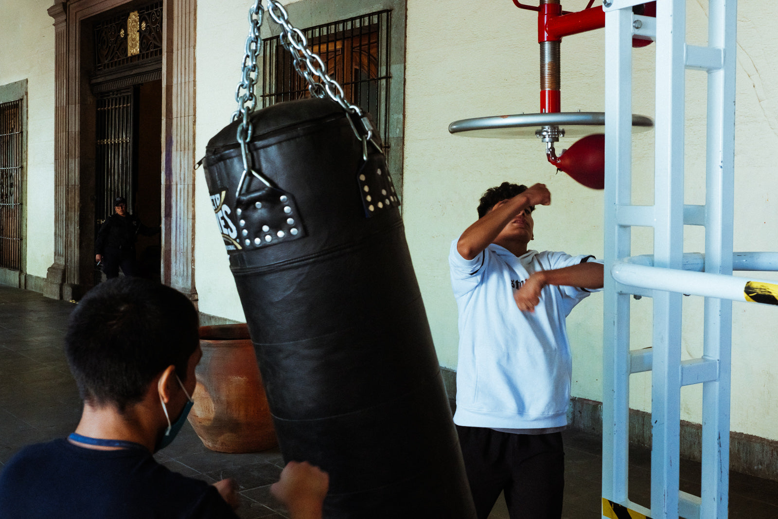 Photographic Art by Nick Sparks of two boys boxing outdoors in Oaxaca.