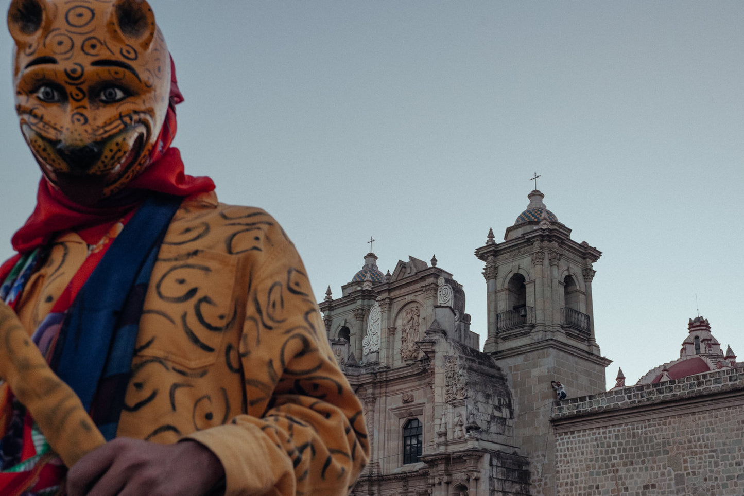 Photographic Art by Nick Sparks of a person in a jaguar custom dancing in front of a church in Mexico.