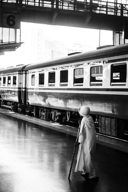 Photographic Art by Nick Sparks of a woman getting off a train in downtown Bangkok. 